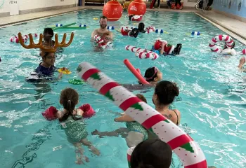 Members in Rooke Pool with Christmas Decorations