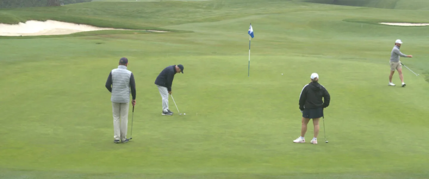 Golfers putting at a tee