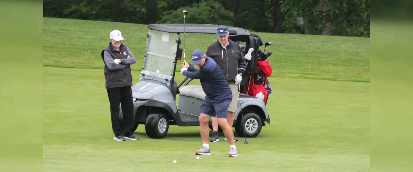 Golfer in front of their cart