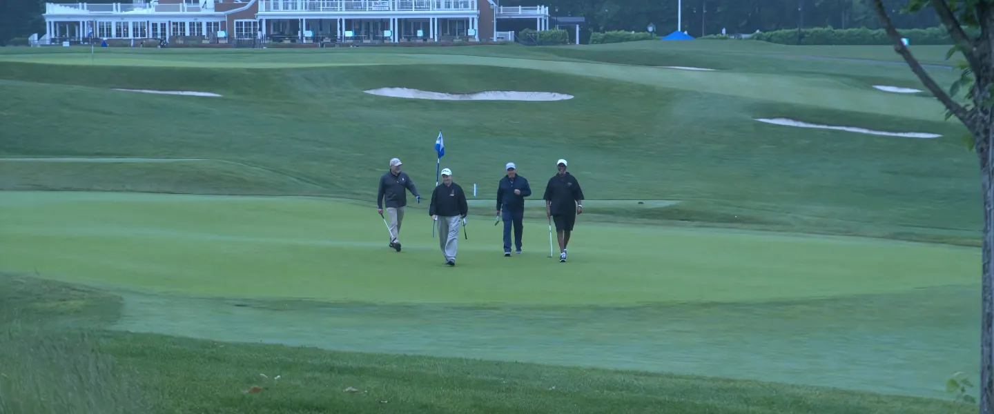 Golfers walking back to their cart